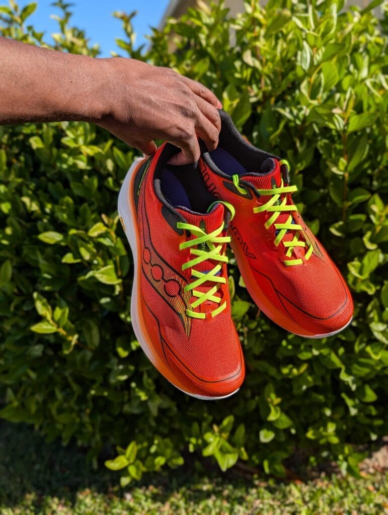 hands holding saucony peregrine 16