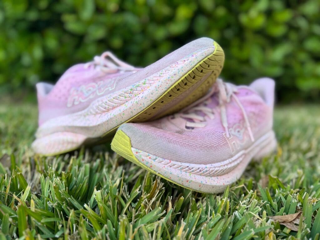 pink hoka mach 6 on grass