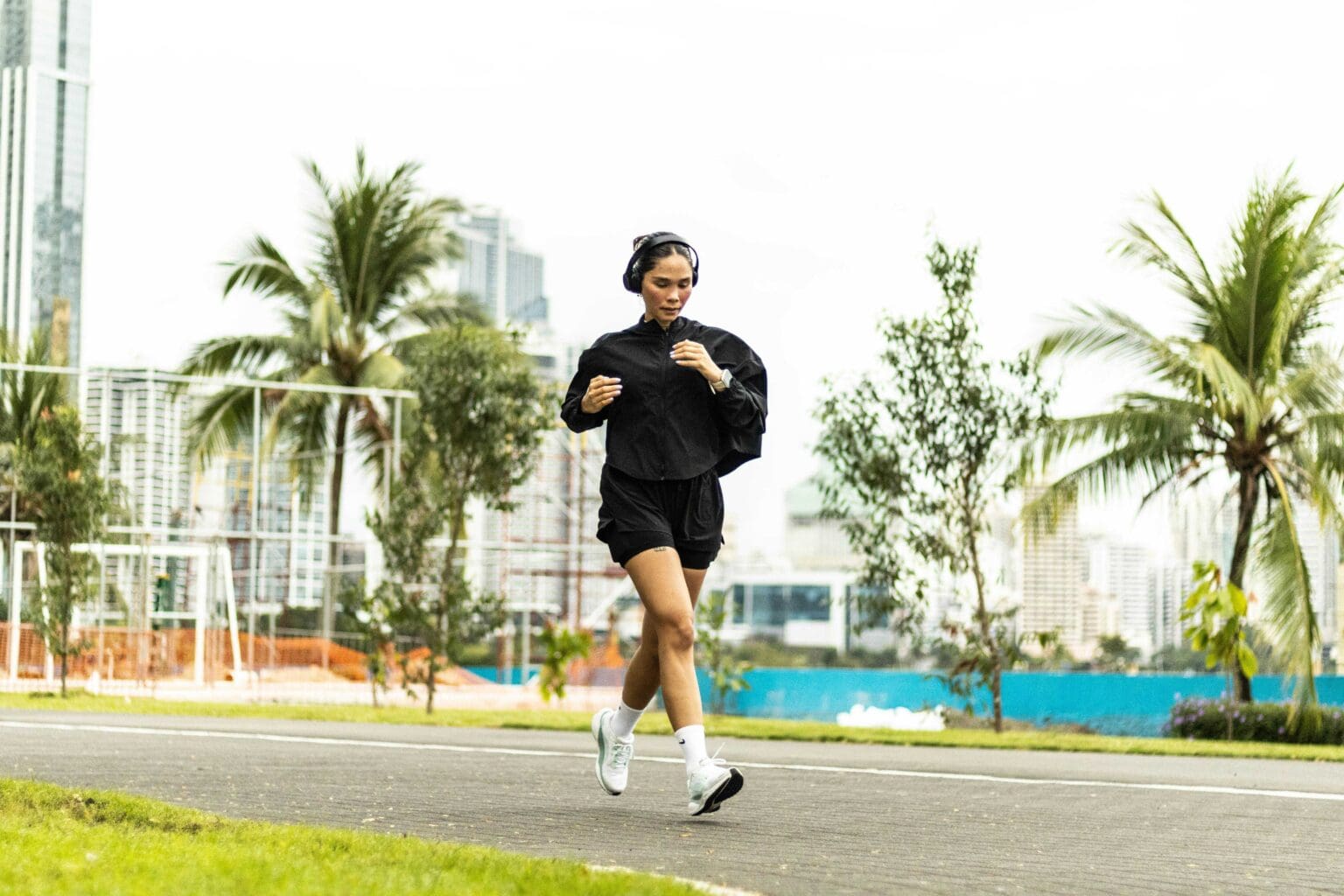 The No-BS Guide to Running in Heat and Humidity girl running outside in direct sunlight