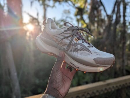 Saucony Xodus Ultra 4 Review: Rugged Comfort Meets Vibram Saucony Xodus Ultra 4 with Sun Beam behind shoe and trail background