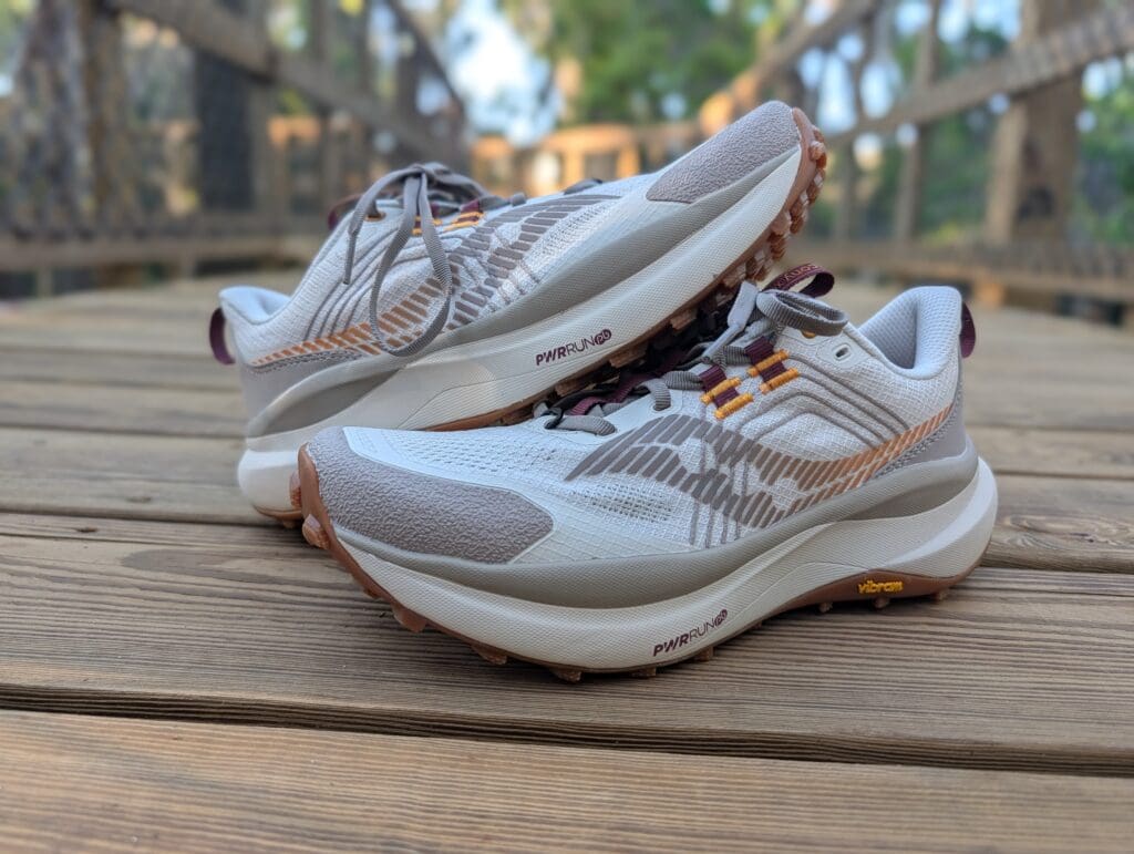 Saucony Xodus Ultra 4 stacked on top of each other on trail bridge