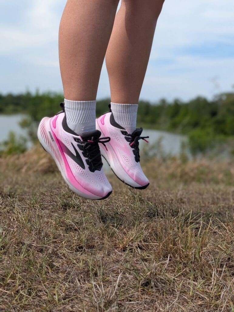Pink Brooks Glycerin 23s on foot with person jumping in air
