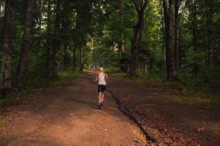 5 Best Road-to-Trail Running Shoes of 2026: Ultimate Guide man running on dirt gravel trail during sunset