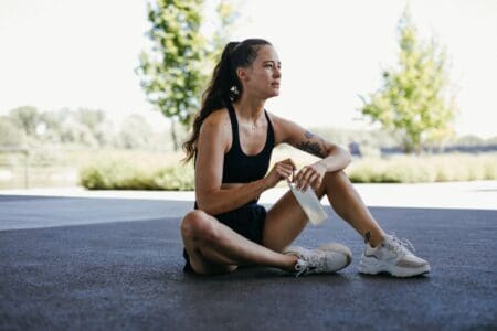 11 Best Recovery Footwear (Shoes, Sandals, and Slides) for Runners girl recovering after workout