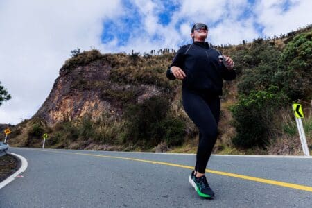 9 Best ASICS Running Shoes (2026): Expert Buying Guide girl running on road wearing asics running shoes