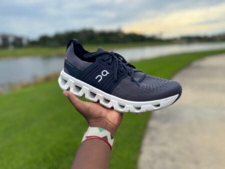 On Cloudswift 4 Review: Firmer, Faster, and City-Ready On Cloudswift 4 in hand with running bath and pond in background