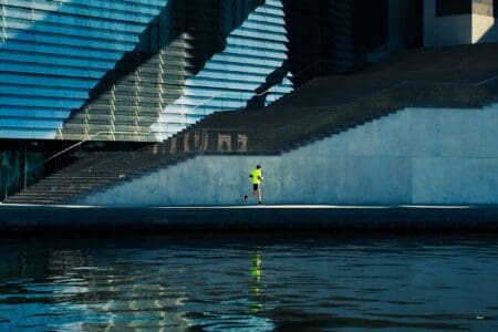 6 Best Running Shoes for High Arches: Protect Your Feet man running outside in city