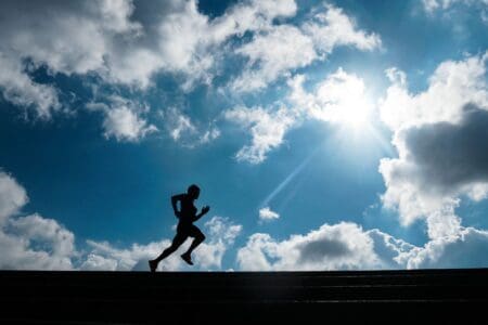 6 Best Running Shoes for Plantar Fasciitis of 2026: Relief Guide man running outside with clouds in background
