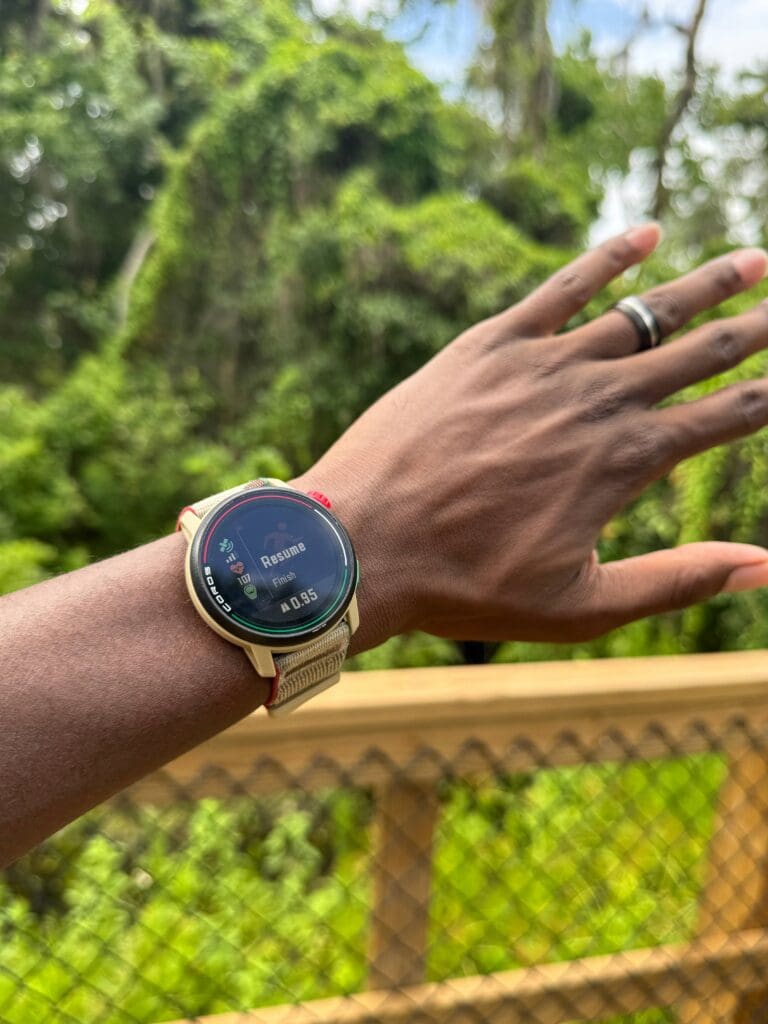 coros pace 3 on wrist with trail in background