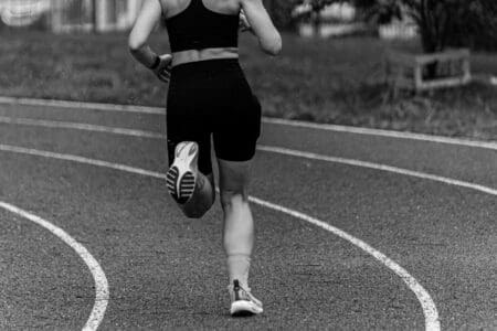 girl running with slightly worn running shoes