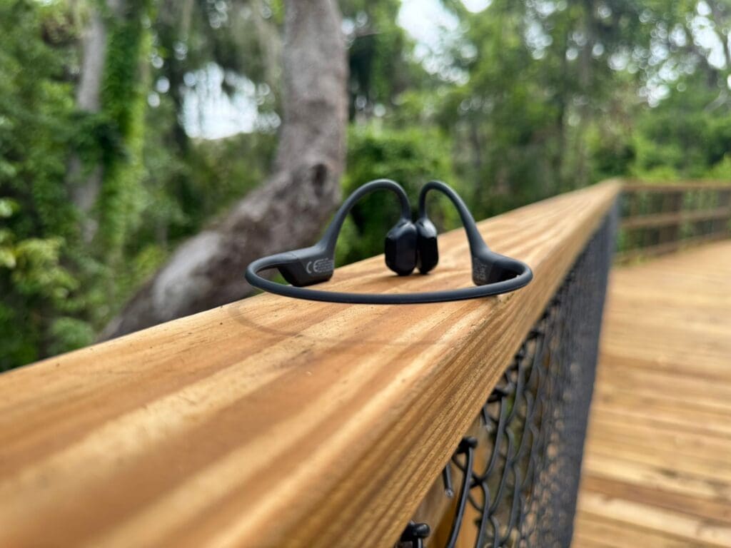shokz open run pro on trail bridge