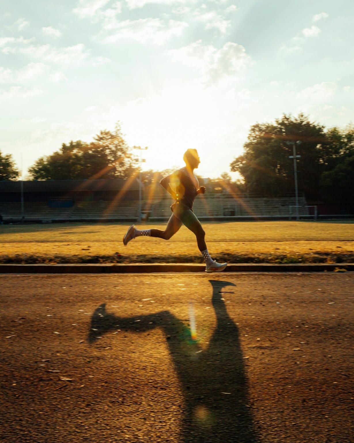 7 Best Saucony Running Shoes of 2026: Road, Trail & Speed man running intervals on track with saucony running shoes
