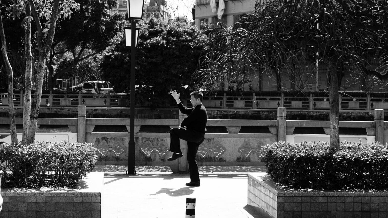 Tai Chi Walking: The Mindful Path to Balance and Strength man doing tai chi walking on sidewalk