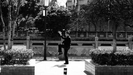 Tai Chi Walking: The Mindful Path to Balance and Strength man doing tai chi walking on sidewalk