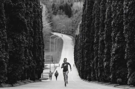 person running uphill in neutral running shoes