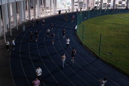 runners running on a track and socializing