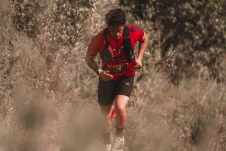 6 Best Running Hydration Vests & Packs: Bounce-Free Gear Runner running with hydration vest during race